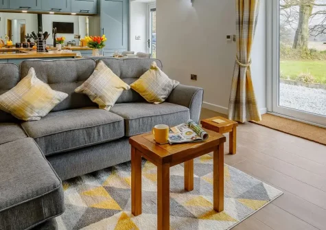 Gidcott Cottage, Gidcott is a luxurious two-bedroom barn conversion featuring a private hot tub and streamside setting. Explore Devon and Cornwall's stunning coast and countryside from this beautifully peaceful rural retreat, perfect for couples.