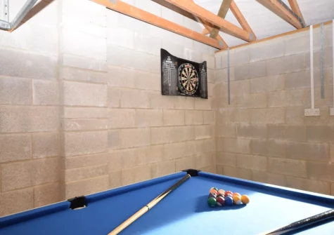 The games room with pool table at Gifford Close Bungalow, Hartland