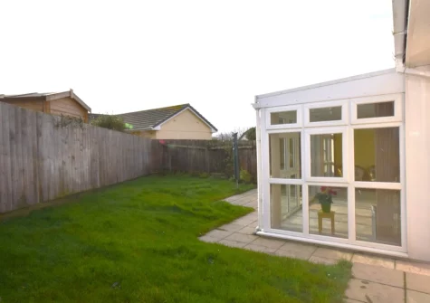 The patio, alfresco dining area & enclosed rear garden at Gifford Close Bungalow, Hartland