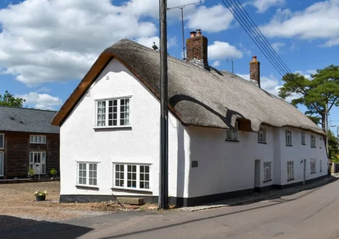 Nestled within a pretty village, Glimsters Cottage boasts original exposed beams, stone walls & lots of welcoming touches
