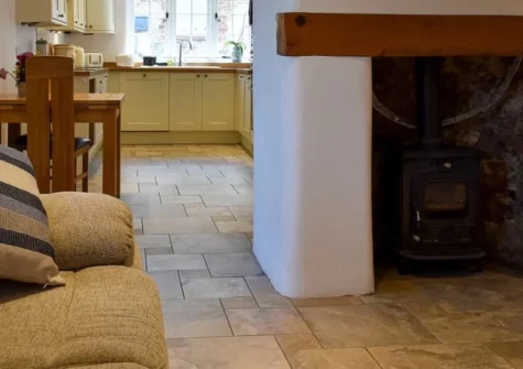 Glimsters Cottage, Kentisbeare is a beautifully restored thatched retreat in peaceful East Devon, featuring exposed beams, original stone walls, a cosy wood burner, and a stream-side patio, with countryside walks starting from the door.