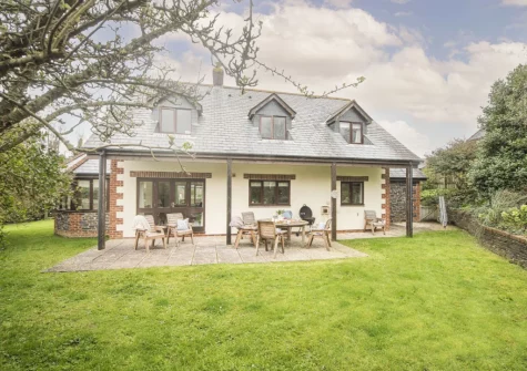 The patio, alfresco dining area & wraparound garden at Godolphin at Roserrow, Polzeath