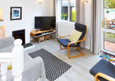 Godrevy Watch, Carbis Bay is a charming two-bedroom cottage just a short distance from Blue Flag Carbis Bay Beach, featuring a private enclosed patio garden, sea glimpses from the double bedroom, and effortless access to nearby St Ives.