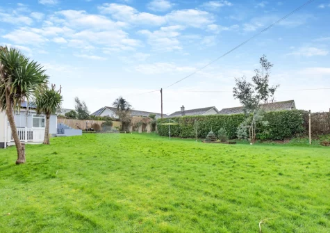 The grass area to the rear of the property, ideal for children to have a run around & play