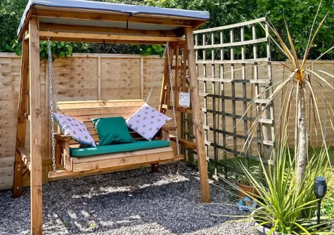 The outdoor sitting area & enclosed garden at Granny McPhee's Cottage, West Chilla
