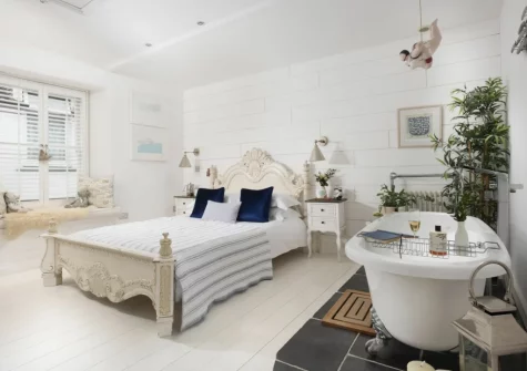 The bedroom, roll-top bath, at Gylly Cottage, Mousehole