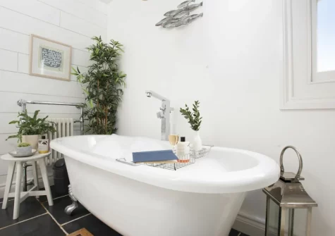 The bedroom, roll-top bath, at Gylly Cottage, Mousehole