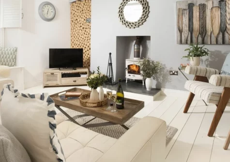 Gylly Cottage, Mousehole is a beautifully styled fisherman's cottage across three floors in this enchanting harbour village, featuring a romantic bedroom with roll-top bath, characterful living spaces, and the seafront just moments away.