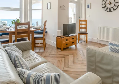 Hannafore at Lemain Garden Apartments, Looe is a spacious three-bedroom apartment with magnificent sea views, a private veranda and terrace, and effortless access to Hannafore Beach, rockpools and the South West Coast Path, ideal for families.