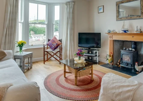 Harbour Lights, Porthleven is a Grade II-listed seaside haven with unrivalled harbour views. Enjoy three bedrooms, spacious living area with wood burner, and stunning patio overlooking the sea, perfect for unforgettable family memories.