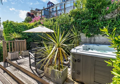 The rear garden, outdoor sitting area & hot tub at Harbour's Reach, Fowey