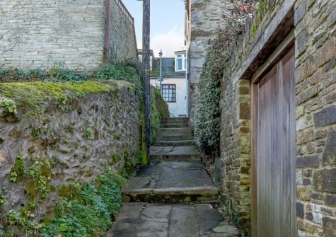 Hart Cottage is approached up stone steps from Betty Hewans