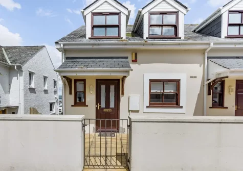 Hartland House is an attractive three-storey property with water views, balcony, enclosed patio garden & parking