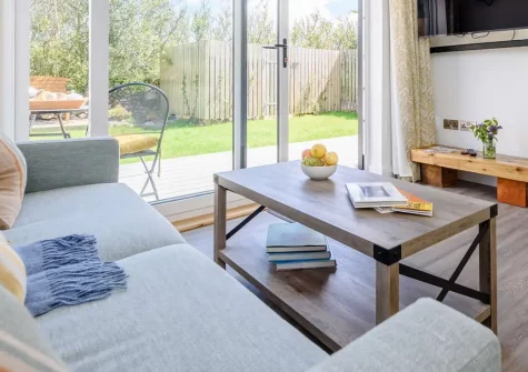 Hartnolls Lodge, Woolacombe is a charming couples' retreat with heated hot tub, private garden, and sea views. Enjoy luxurious open-plan living, quality furnishings, and easy access to stunning North Devon beaches. Perfect for a romantic escape.