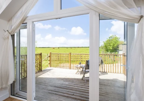 Step out on to the decked balcony & outdoor sitting area at Hayloft at Trevissick Farm, Porthtowan