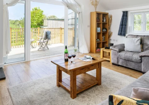 Hayloft at Trevissick Farm, Porthtowan, is a stylish reverse-living barn conversion for a romantic Cornish escape. Enjoy countryside views towards Carn Brea, a cosy wood-burner, and a short stroll to Porthtowan's beach, coastal path, and pubs.