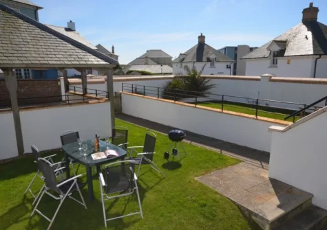 The barbecue, alfresco dining area & south-facing enclosed garden at Headland House, Newquay