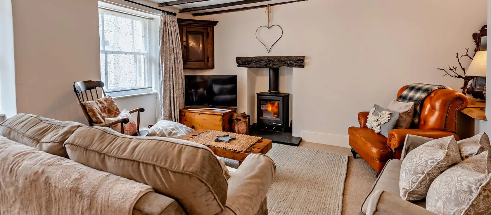 Heanton Cottage, Braunton is a charming village retreat featuring a magnificent inglenook fireplace, dual vine-covered patios, and with perfect access to North Devon's award-winning beaches including Woolacombe and surfing adventures.
