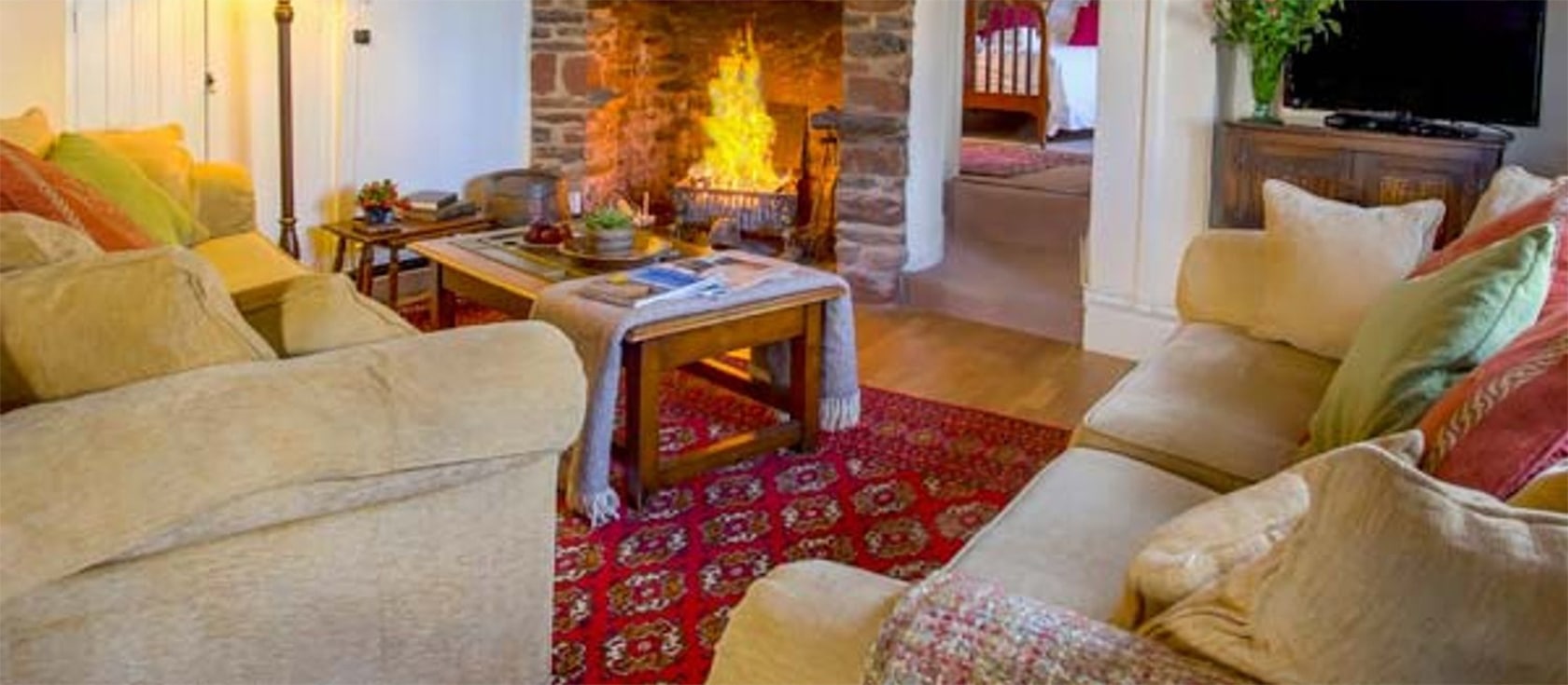 Hearthstone East Cottage, Brixham is a traditional thatched Devon Longhouse with fireplace & original features. Open plan dining kitchen with dishwasher. Four antique-filled bedrooms & two modern bathrooms (one ensuite), garden & off-road parking.