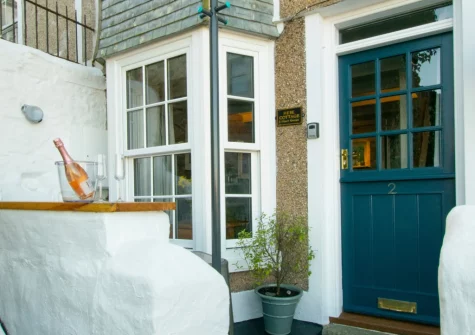 The small front yard, with high stone wall that doubles as a bar-style table, at Hebe Cottage, St Ives