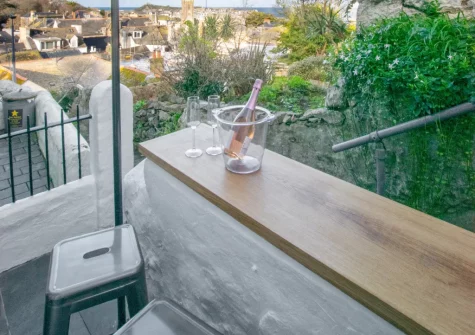 The small front yard, with high stone wall that doubles as a bar-style table, at Hebe Cottage, St Ives