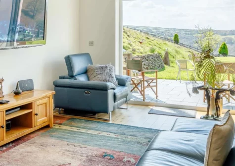 Heddon's View, Trentishoe is a spectacular four-bedroom property nestled in the beautiful Heddon Valley, featuring floor-to-ceiling windows showcasing dramatic Exmoor views, spacious open-plan living, and direct access to stunning coastal walks.