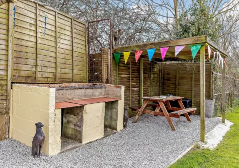 The barbecue, alfresco dining & enclosed garden at Here Tiz, St Day