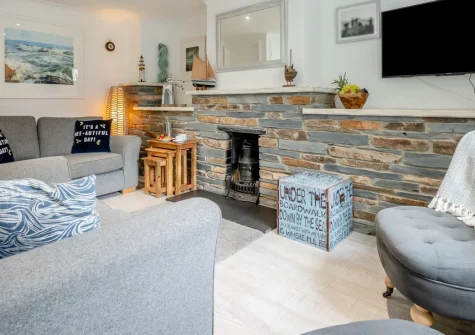 Hideaway Cottage, Padstow is a charming three-storey townhouse tucked down a quiet alley near the harbour, featuring en-suite bedrooms, a pretty shared courtyard, and estuary views, perfectly placed for exploring Padstow's shops and restaurants.