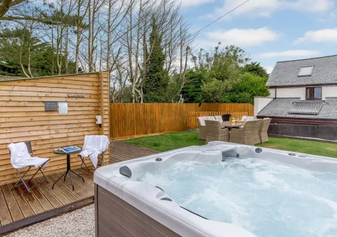 The hot tub & outdoor sitting area at High Meadows Barn, Trewolla