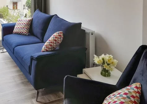 High Tide, Combe Martin is a spacious ground-floor apartment just 300 metres from the beach, featuring a sunny two-level patio garden with sea glimpses towards Wales, contemporary interiors, and the South West Coast Path moments from your door.