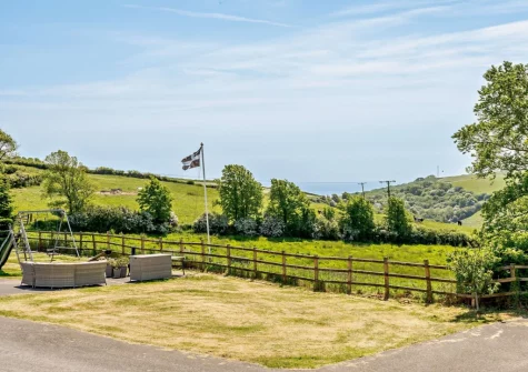 The shared lawn area with comfortable seating & picnic tables at High View, Crumplehorn