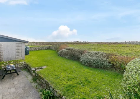 The patio, babecue, alfresco dining area & rear garden at Highcliff Cottage, Sennen
