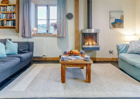 Highcliff Cottage, Sennen is a charming two-bedroom retreat near Cornwall's dramatic western coast, featuring two gardens with distant sea views, cosy living spaces with wood burner effect fire, and easy access to Sennen Beach and coastal walks.