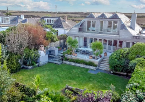 The patio, alfresco dining, barbecue area & well manicured mature garden at Higher Close, Mawgan Porth