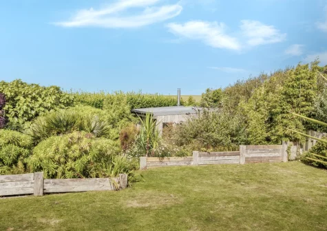 The mature garden & detached eco games room at Higher Close, Mawgan Porth