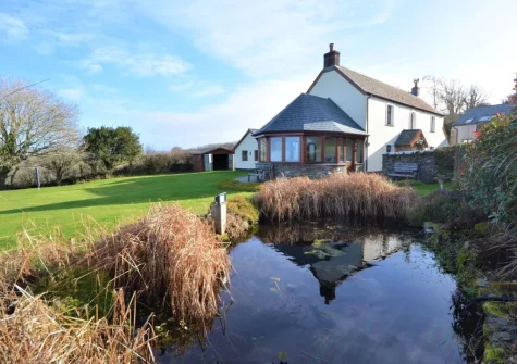 The large, enclosed, lawned garden & pond at Higher Hodges Farmhouse, Combe Martin