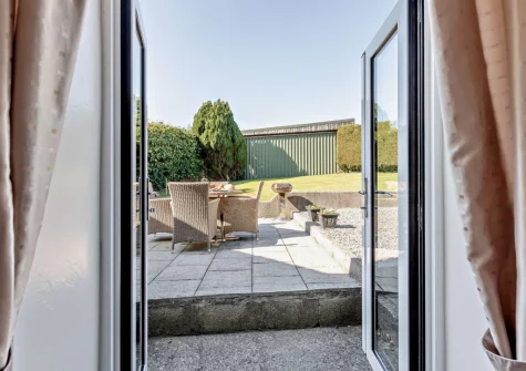 Step out onto the patio, barbecue & alfresco dining area at Higher Hopworthy Cottage, Pyworthy