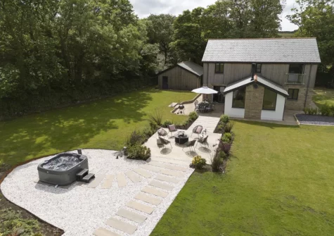 The terrace, alfresco dining area, outdoor sitting area, hot tub & garden at Highfield Barton, Camborne