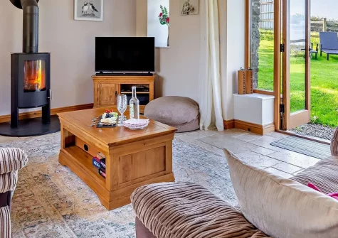 Highford Barn, Higher Clovelly is a charming barn conversion near Clovelly village, offering authentic countryside living with modern comforts, enclosed gardens, and direct access to stunning coastal attractions and adventure activities.