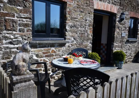 The front patio & outdoor sitting area at Hill Farm Fox Barn, Shebbear