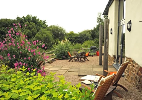 The enclosed gravelled patio, barbecue & alfresco dining area at Holder's Barn, Monkokehampton