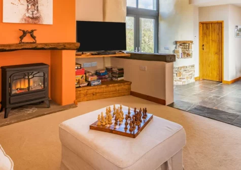 Holder's Barn, Monkokehampton is a beautifully converted detached barn in peaceful Devon countryside, featuring vaulted ceilings with exposed beams, two en-suite bedrooms, and an enclosed garden with far-reaching rural views, close to Dartmoor.