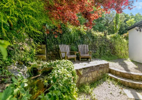 The rear garden outdoor sitting area at Hollow Tree Cottage, Cambrose