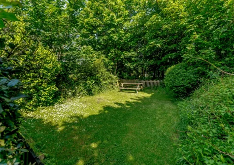 The rear secluded garden with picnic table at Hollow Tree Cottage, Cambrose