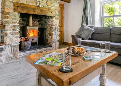 Hollow Tree Cottage, Cambrose is a traditional three-bedroom retreat in peaceful countryside near Porthtowan, featuring two wood burners, enclosed gardens with fish pond, and direct access to the Coast to Coast mining trail for cycling adventures.