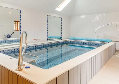 The shared heated indoor endless swimming pool at Honeypin, South Torfrey Farm, Golant