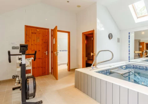 The shared heated indoor endless swimming pool & sauna at Honeypin, South Torfrey Farm, Golant