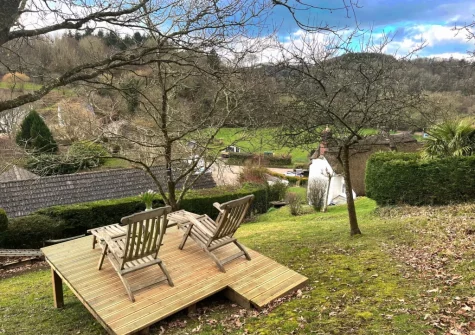The rear garden & outdoor sitting area at Honeysuckle Cottage, Weare Giffard
