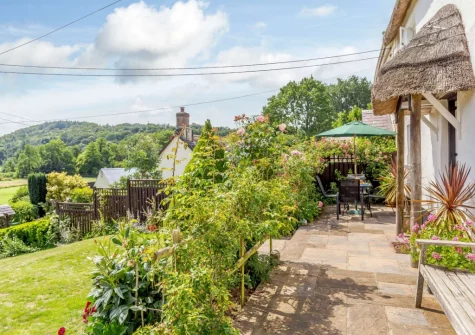 The patio, alfresco dining area & garden at Honeysuckle Cottage, Weare Giffard
