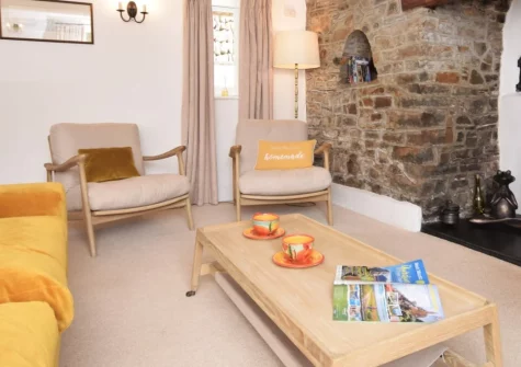 Honeysuckle Cottage, Weare Giffard is a beautiful Grade II-listed thatched retreat overlooking the River Torridge, featuring peaceful front patio, extensive hillside gardens with valley views, and the Tarka Trail accessible from the village.